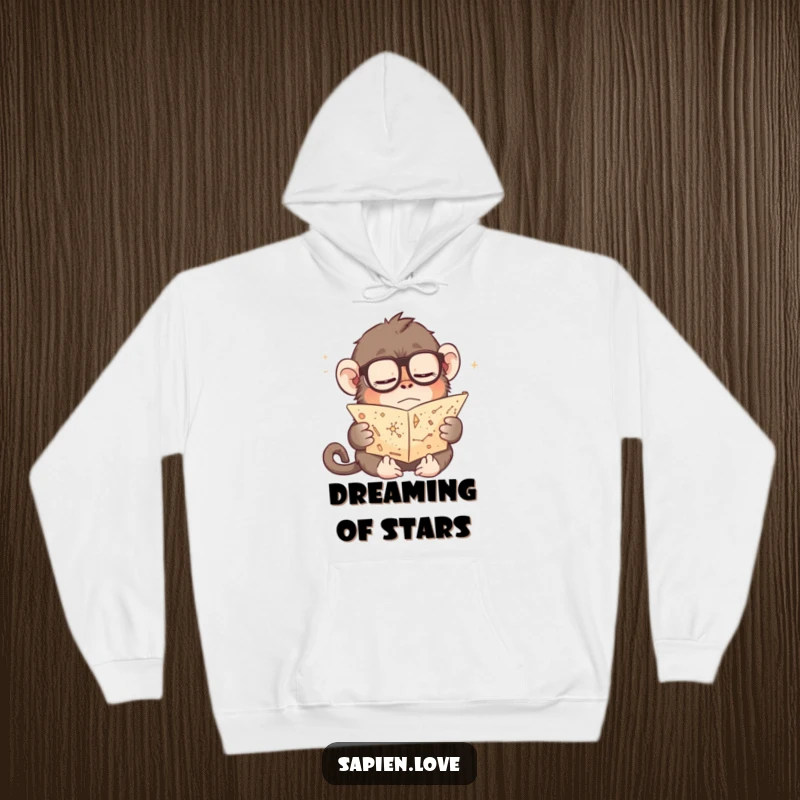 Funny hoodie featuring a slumbering ape in eyeglasses, engrossed in a tiny scroll of constellations, perfect for cozying up during astronomical observations.